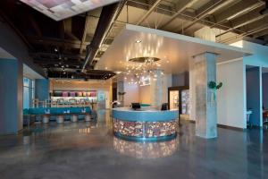 a lobby with a bar in the middle of a building at Aloft - Tampa Downtown in Tampa