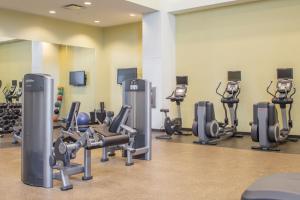 a gym with several tread machines in a room at Marriott Louisville East in Louisville