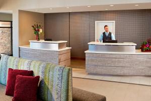 a man standing at a counter in a hotel lobby at Residence Inn by Marriott Los Angeles Redondo Beach in Redondo Beach +32 photos