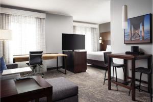 a hotel room with a bed and a living room at Residence Inn by Marriott Los Angeles Redondo Beach in Redondo Beach