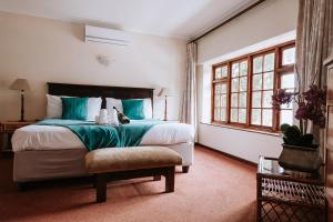 a bedroom with a large bed and a window at Floreal House in Cape Town