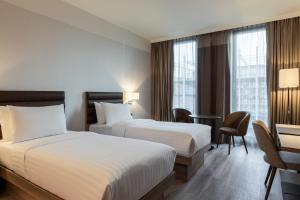 Postel nebo postele na pokoji v ubytování AC Hotel by Marriott Wuerzburg + 26 fotografií