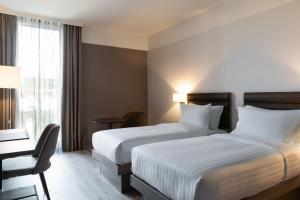 Postel nebo postele na pokoji v ubytování AC Hotel by Marriott Wuerzburg