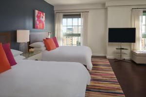 a hotel room with two beds and a flat screen tv at Hotel Colonnade Coral Gables, Autograph Collection in Miami