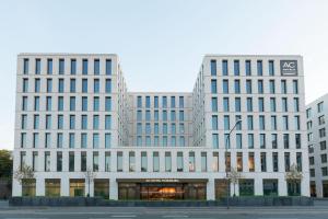 two white buildings in a city at AC Hotel by Marriott Wuerzburg in Würzburg