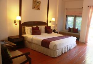 a bedroom with a large bed in a hotel room at Banburee Resort & All Spa Inclusive in Laem Set Beach