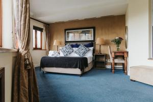 1 dormitorio con 1 cama con almohadas azules y blancas en Floreal House, en Ciudad del Cabo
