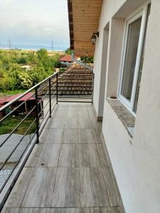 a balcony with a wooden floor and a railing at Casa Edental in Orăştie