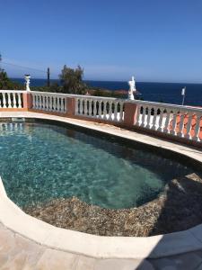 a swimming pool with the ocean in the background at Villa Elisabeth Saint-Raphaël in Saint-Raphaël