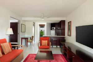 a living room with a couch and a flat screen tv at Sheraton Denarau Villas in Denarau