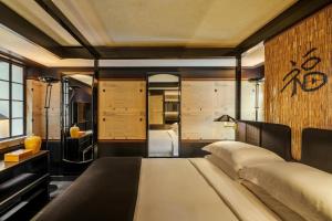 a bedroom with a large bed in a room at Duxton Reserve Singapore, Autograph Collection in Singapore