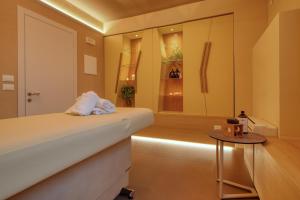 a room with a bed and a table at Hotel Palazzo del Garda & Spa in Desenzano del Garda
