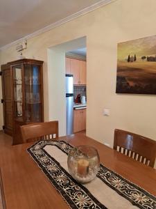 a kitchen and dining room with a wooden table at Casa del Centro Storico in Corfu Town