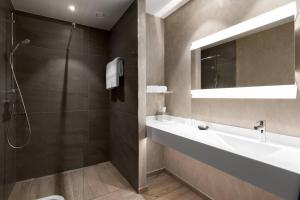 a bathroom with a sink and a shower at AC Hotel by Marriott Wroclaw in Wrocław