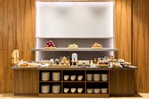 a display case with desserts and pastries on it at AC Hotel by Marriott Wroclaw in Wrocław