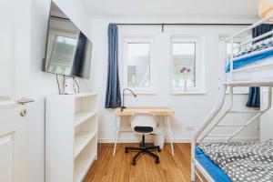 a bedroom with a desk and a bunk bed at Zur Oie 27b in Bresewitz