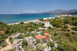 an aerial view of a house with a beach at Mythos Bungalows in Potos