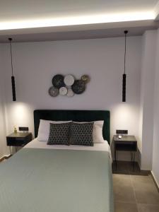 a bedroom with a large bed with two plates on the wall at Studios Periklis in Limenas