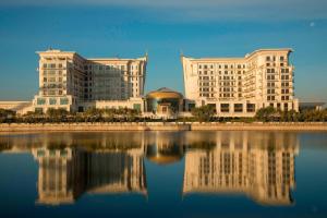 two large buildings next to a large body of water at The St. Regis Astana in Astana