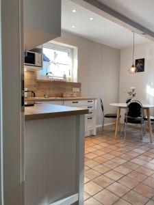 a kitchen with a table and a dining room at Nordseejuwel in Friedrichskoog-Spitz