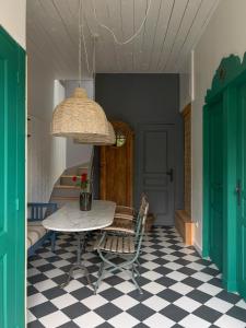 a dining room with a table and a checkered floor at Appartement privé dans un hôtel particulier d'hôtes avec piscine & spa Libourne, Saint-Emilion in Libourne +14 photos