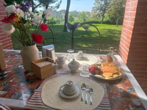 a table with a plate of food on a table at VALLELY la collina sul mare B&B d'Abruzzo in Francavilla al Mare