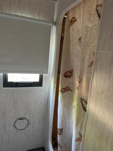 a shower in a bathroom with a shower curtain at Ruime 6 persoons Orlando Super in De Pol