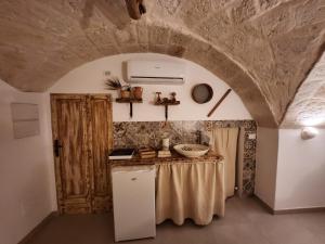 a kitchen with a counter and a sink in a room at Nene' in Fasano