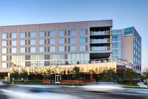 an office building with cars in front of it at AC Hotel by Marriott Irvine in Irvine