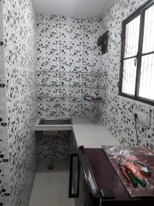 a kitchen with a sink and a counter in a room at Chabbra niwas kanpur in Kānpur