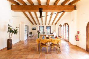 a dining room with a table and chairs at Can Morei in Orp&iacute;