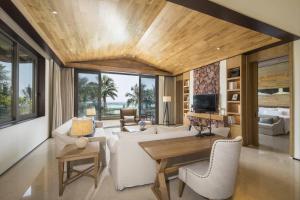 a living room with a white couch and a table at The Westin Shimei Bay Resort in Wanning
