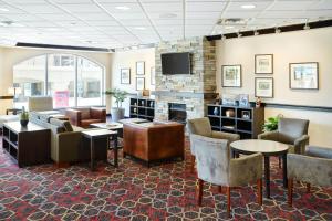a lobby with a waiting room with furniture and a tv at Four Points by Sheraton Halifax in Halifax