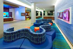 a lobby with blue chairs and a waiting room at SpringHill Suites by Marriott at Anaheim Resort Area/Convention Center in Anaheim