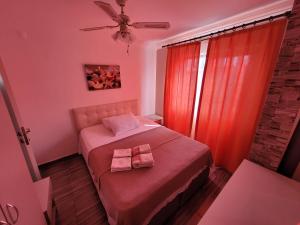 a bedroom with a bed with two towels on it at Apsa Butik Hotel in Sukhum