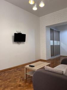 a living room with a couch and a coffee table at apartments of Saint Theodore in Lviv