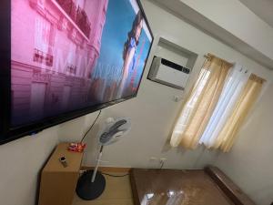 a room with a flat screen tv and a fan at MISR Silence in Manila