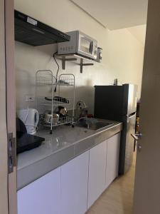 a kitchen with a sink and a microwave at MISR Silence in Manila