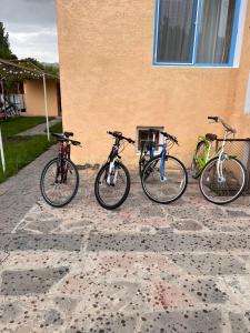 a group of three bikes parked next to a building at Brewery House&Beer Spa in Aspindza