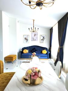 a living room with a table with flowers on it at Luxury Penthouse with Large Terrace & Panoramic Old Town View in Vilnius