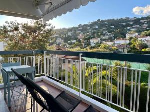 a balcony with chairs and a view of a city at Golfe Juan Studio in Vallauris