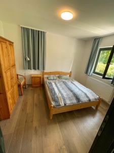 a bedroom with a wooden bed in a room at Agroger Üdülő in Balatonudvari +22 photos