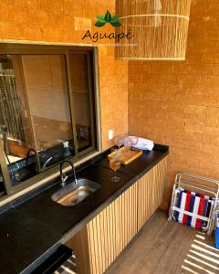 a kitchen with a sink and a counter top at Milagres Aguapé Beach House in São Miguel dos Milagres