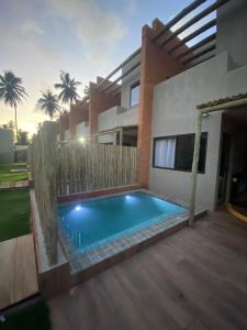 a swimming pool in the backyard of a house at Milagres Aguapé Beach House in São Miguel dos Milagres