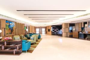 a lobby with blue chairs and a waiting room at Fairfield by Marriott Visakhapatnam in Visakhapatnam