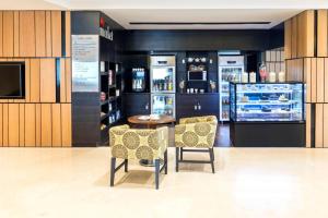 a store with two chairs and a counter with drinks at Fairfield by Marriott Visakhapatnam in Visakhapatnam