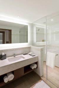 a bathroom with a sink and a shower at Fairfield by Marriott Visakhapatnam in Visakhapatnam