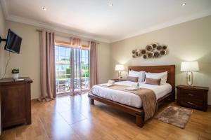 a bedroom with a bed and a large window at Villa Iris in Galé +54 photos