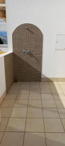 a bathroom with a shower with a tiled floor at Apartamento Sol e Mar in Vila Nova de Cacela