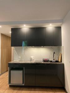 a kitchen with black cabinets and a counter top at Apartament 221 przy Niedźwiadku in Polanica-Zdrój